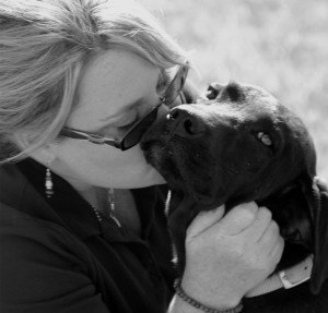 Woman kisses dog